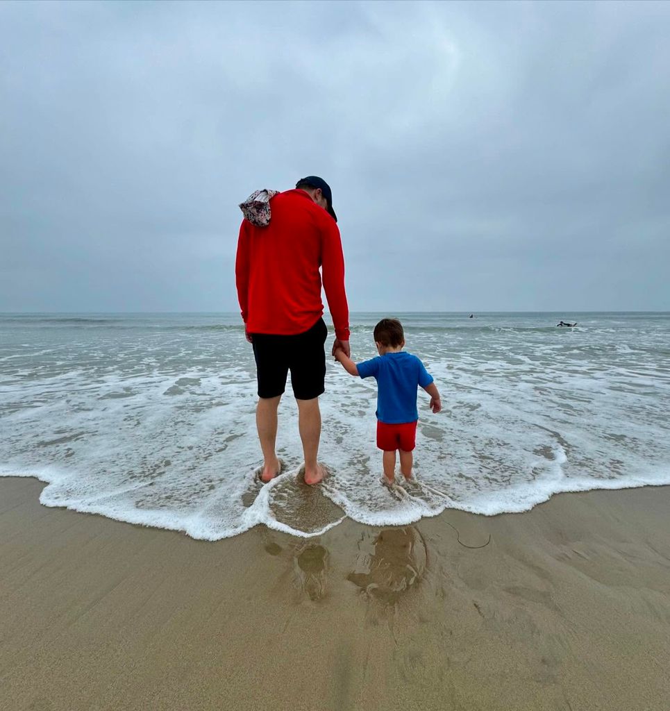 the back of michael kaplan and son henry on the beach