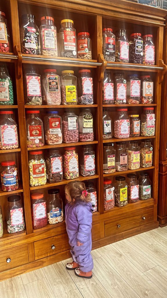 Romy was pictured admiring a wall of sweets 