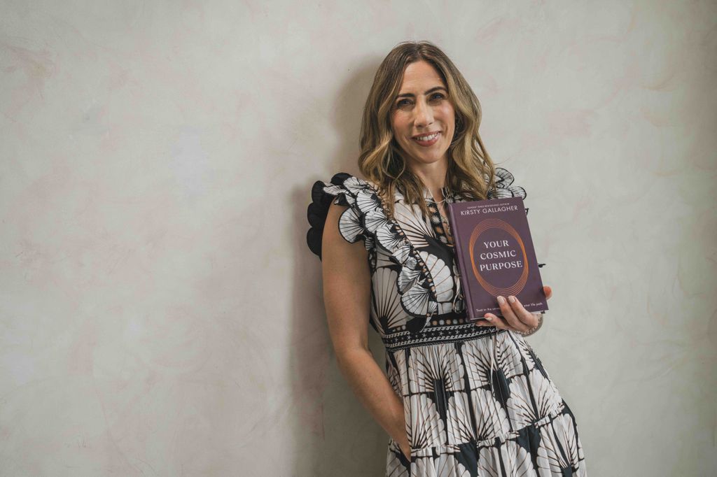 Kirsty holding a copy of her book 