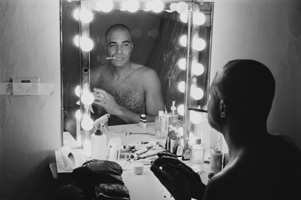 American actor James Earl Jones looking at his reflection in a mirror in a dressing room before going on stage to appear in the play 'The Great White Hope' as 'Jack Jefferson', Broadway, US, 10th December 1968.