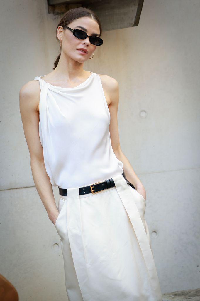 Bambi Northwood-Blyth wearing Bianca Spender white top, beige skirt and black belt during Australian Fashion Week 