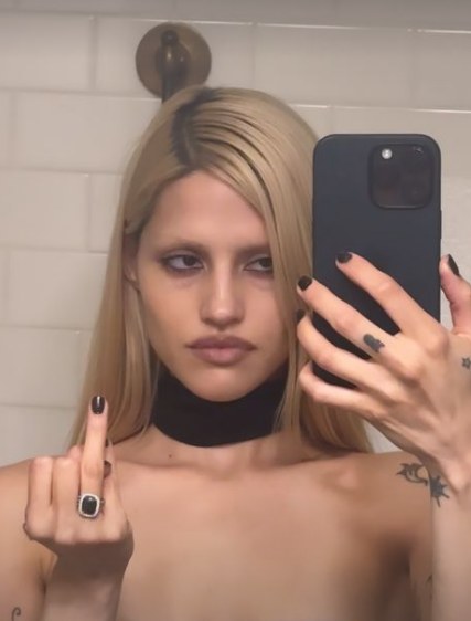 Woman showing an engagement ring in a selfie