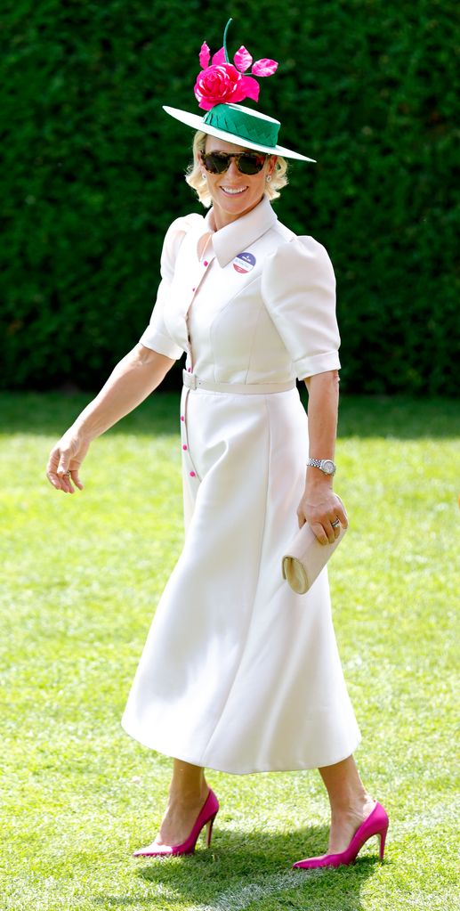  Zara Tindall wearing white dress with pink buttons and heels as she attends day 3 'Ladies Day' of Royal Ascot at Ascot Racecourse on June 16, 2022 in Ascot, England