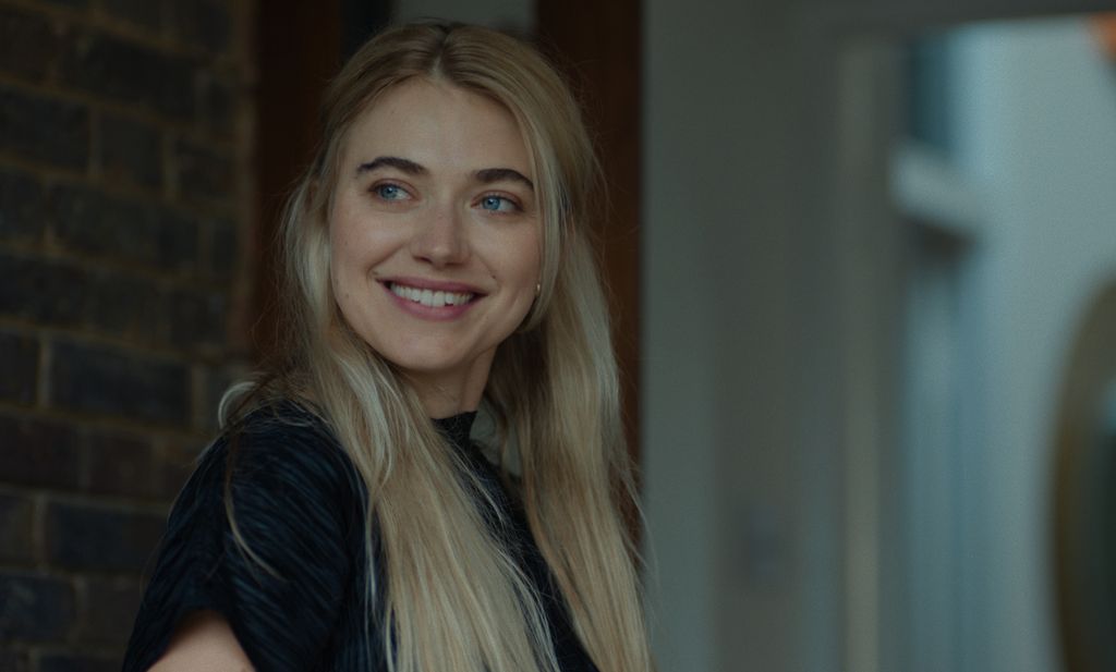 A blonde woman smiling
