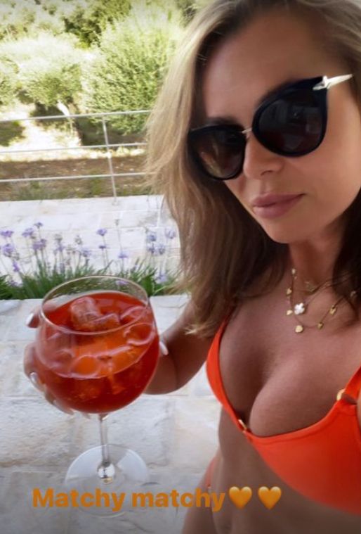 Amanda Holden in an orange bikini holding an aperol spritz
