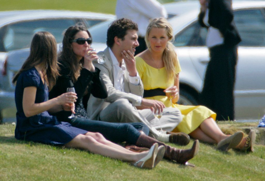 Pippa Middleton and Princess Kate sitting on the floor drinking 