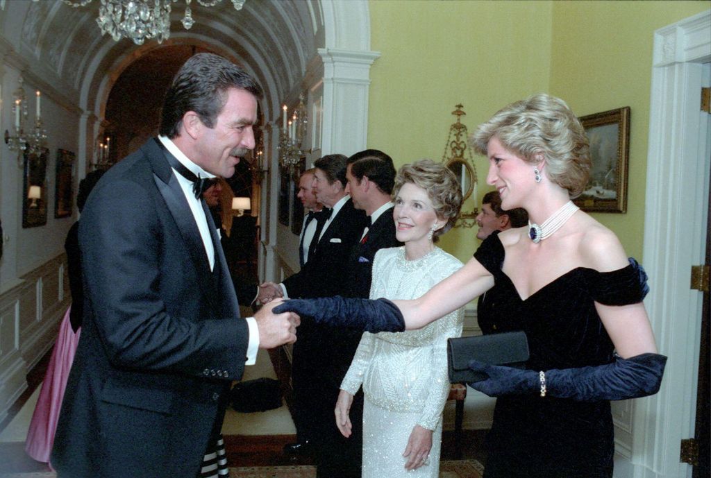 Princess Diana is greeted by Tom Selleck, behind them Nancy Reagan, at a White House state dinner on November 9, 1985.