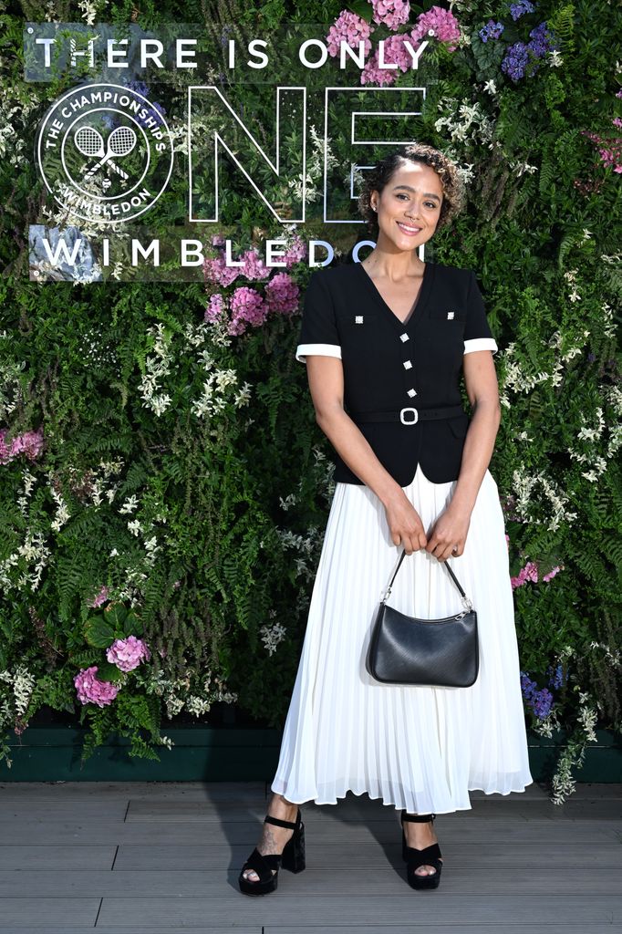 nathalie emmanuel at wimbledon in white skirt and navy jacket