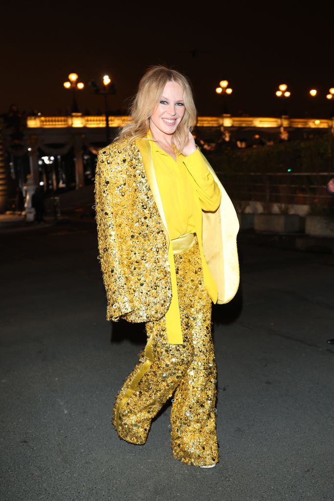 Kylie Minogue in gold suit with yellow shirt
