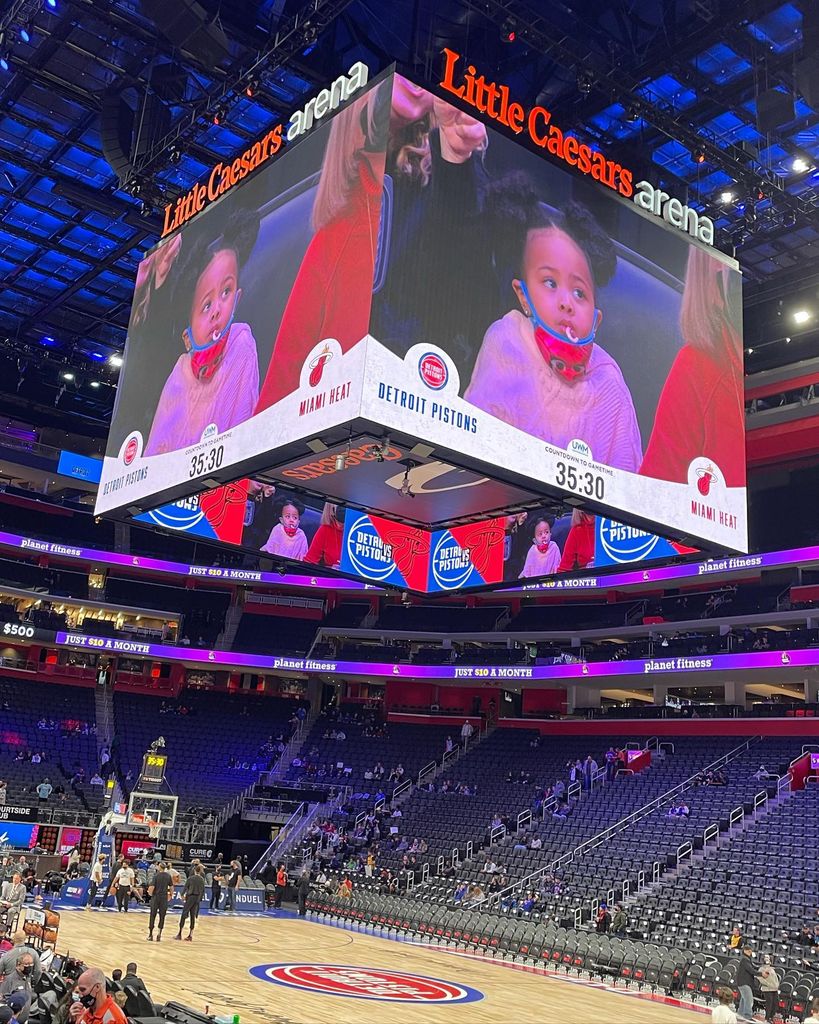 photo of cade cunningham daughter riley on the big screen at a basketball game