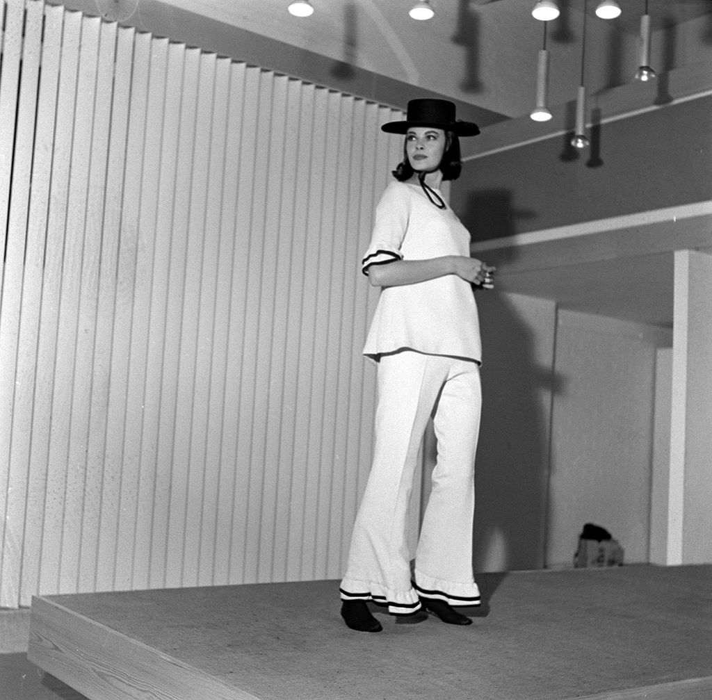 Women's fashion 1962: Model wearing flared trousers and matching white top with detail at the hem, also wearing black wide brimmed hat. Designed by Mary Quant. 13th September 1962. (Photo by Doreen Spooner/Daily Mirror/Mirrorpix via Getty Images)