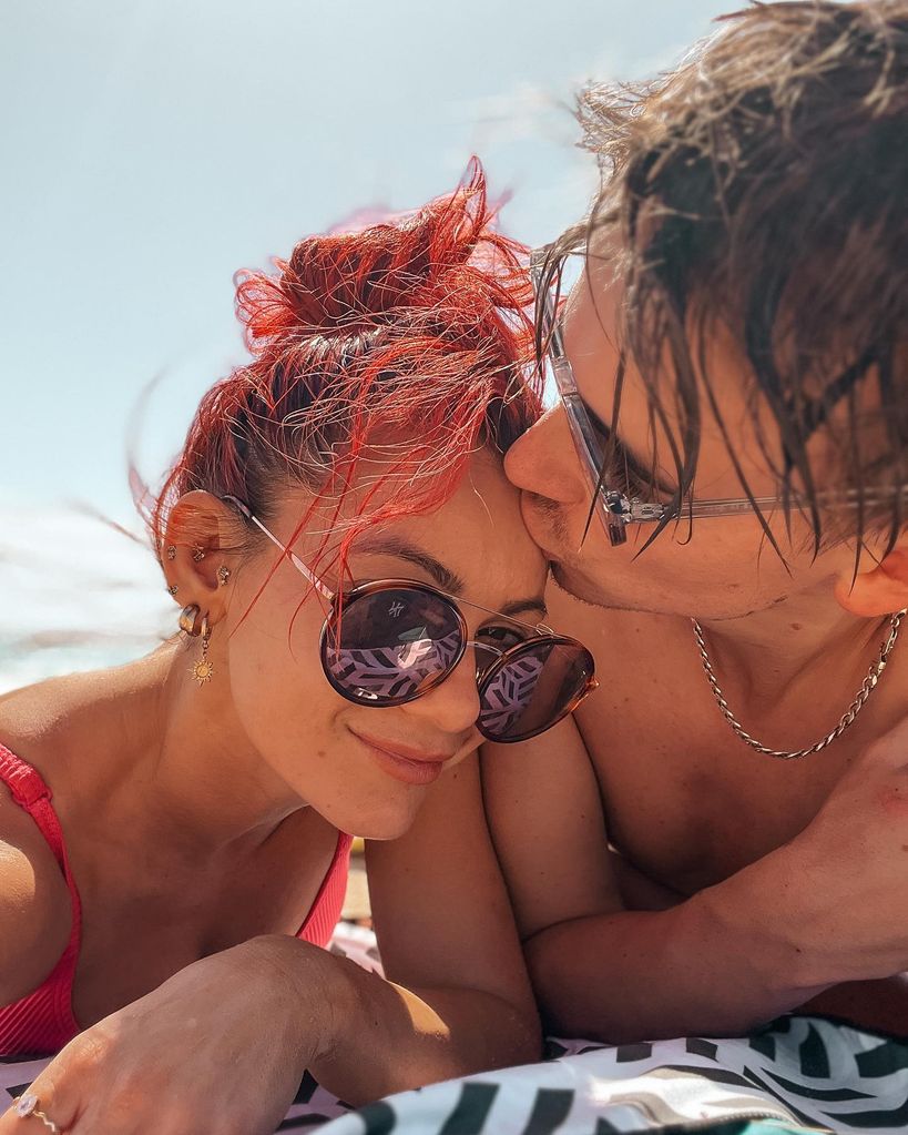boyfriend kissing girlfriend on head 
