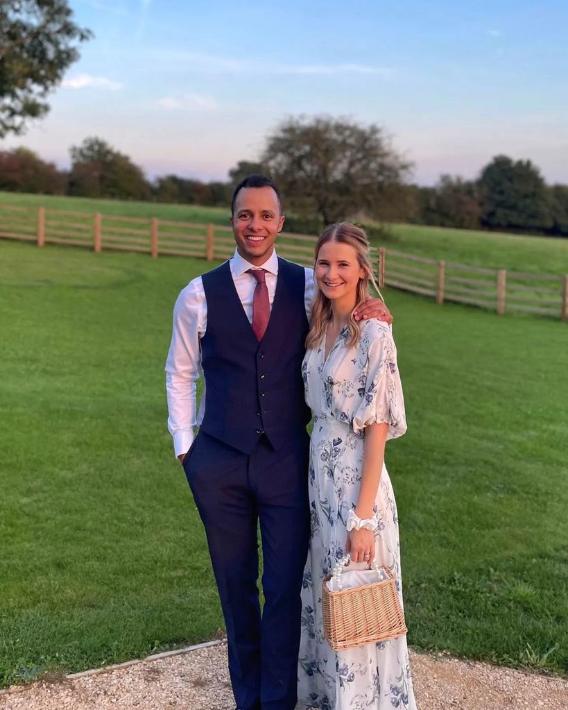 Will Kirk in navy suit posing with wife Polly Snowdon in white dress at wedding 