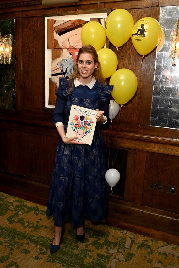Princess Beatrice poses with Jarvis's winning book 'The Boy With Flowers in His Hair' during the Oscar's Book Prize Winner Announcement
