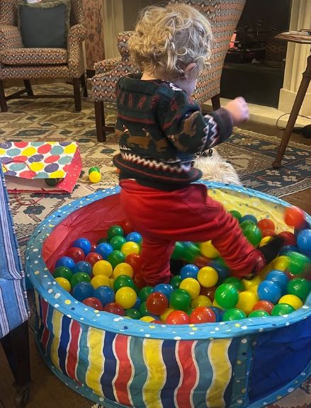 A young boy playing in a ball pit