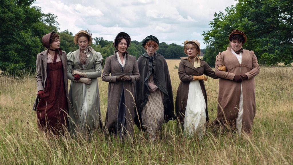 women walking through field