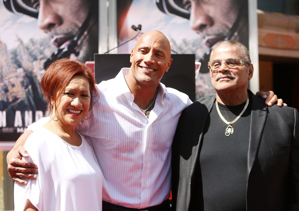 Dwayne with his parents in 2015 at his hand/footprint ceremony smiling