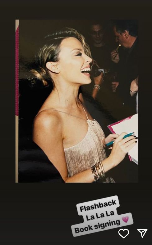Kylie Minogue signing a book
