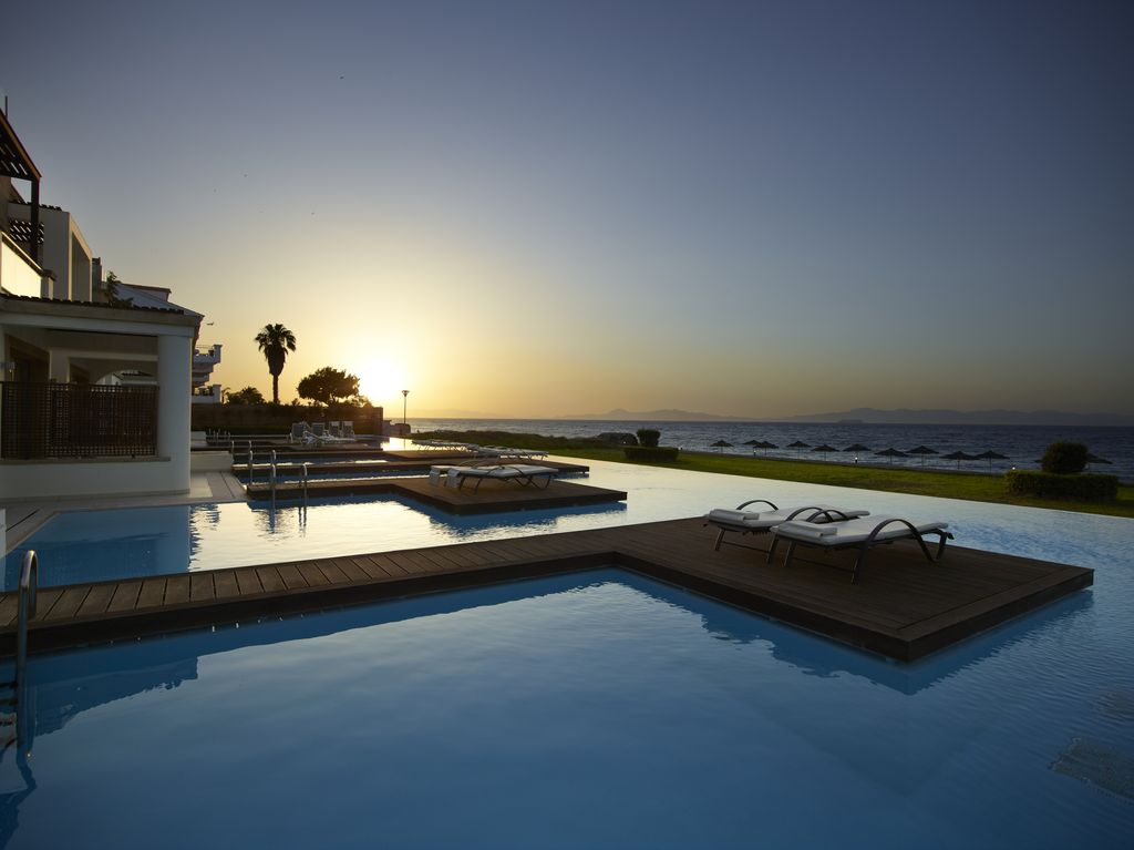 sunset view in the private swim-up pool at The Ixian Grand & All Suites 