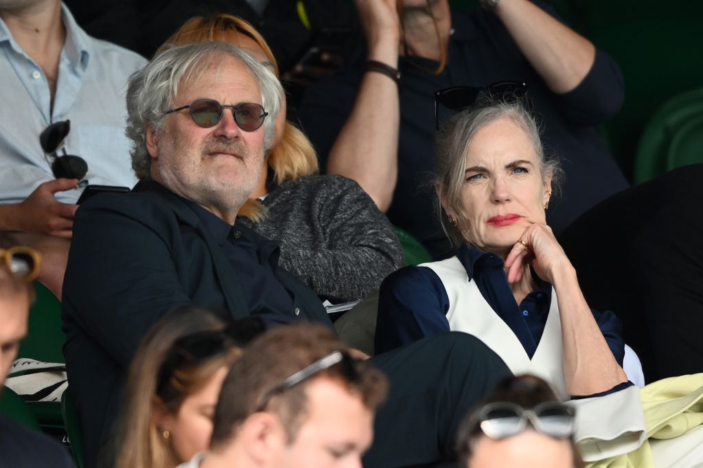 Simon Curtis and Elizabeth McGovern sit in stands to tennis at Wimbledon 2023