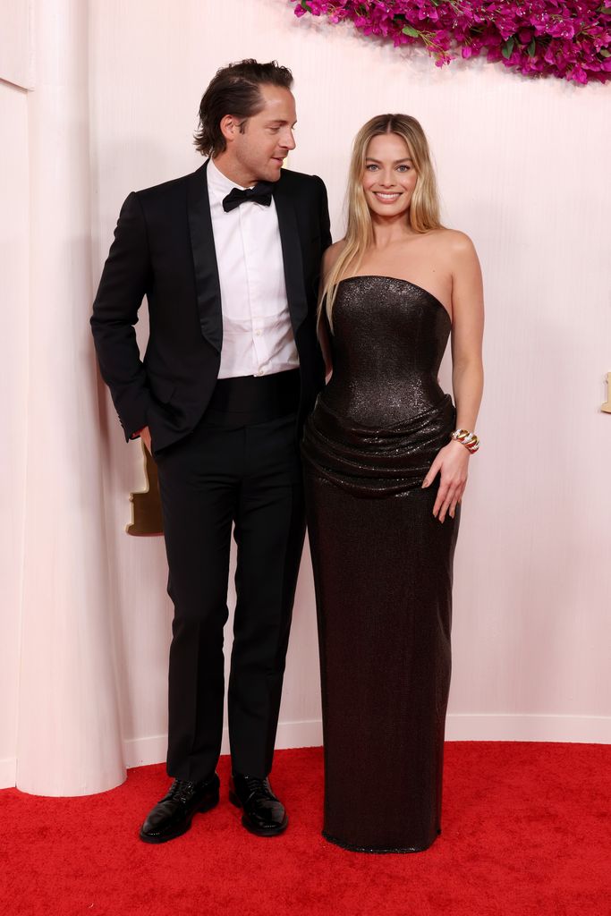 Tom Ackerley and Margot Robbie attends the 96th Annual Academy Awards