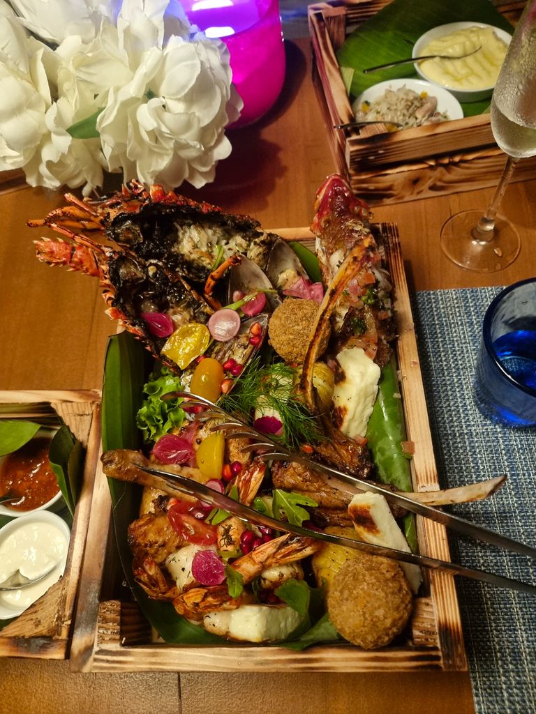 Lobster served in a basket with tiger king prawns and lamb rack