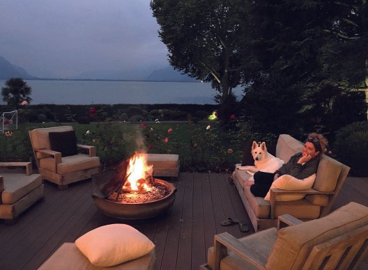 Shania sat by her fire in the garden with her dog