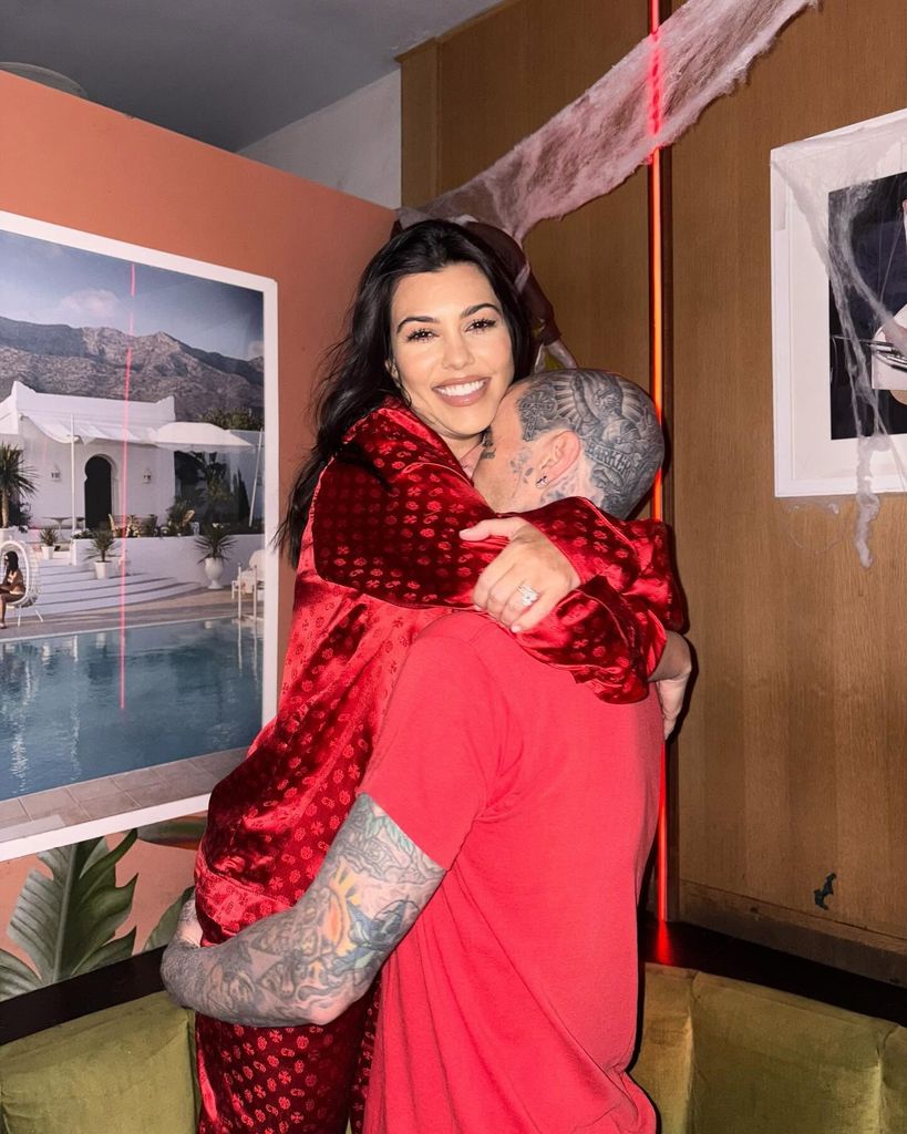 Kourtney Kardashian hugging husband Travis Barker 