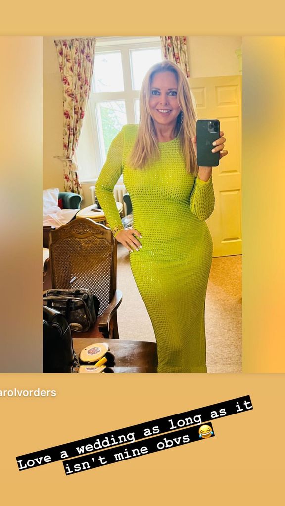Carol Vorderman taking a mirror selfie in a green sparkly dress