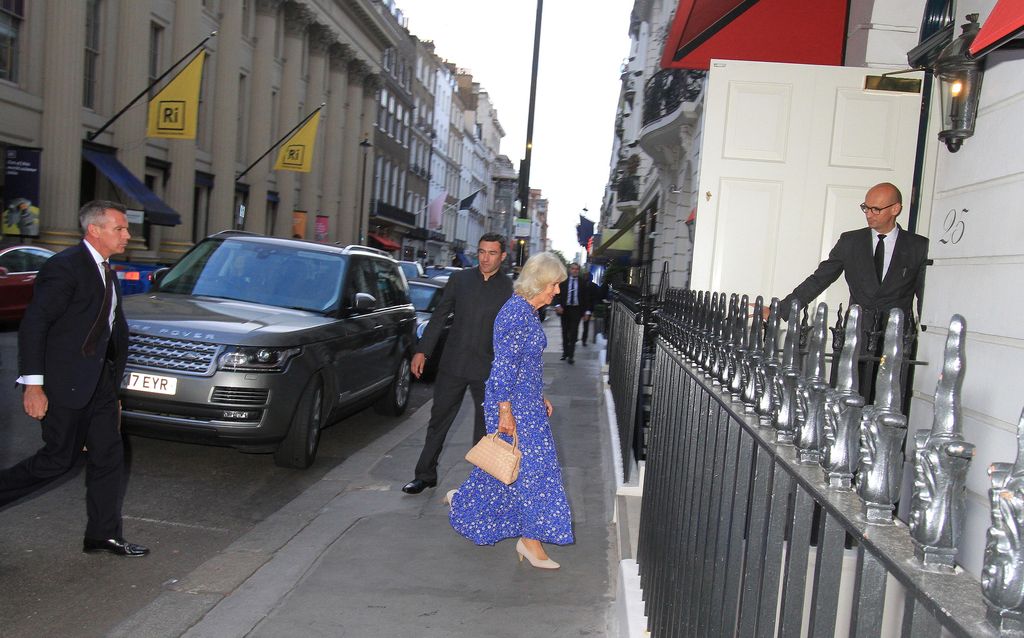 Faraway shot of Queen Camilla walking into a club
