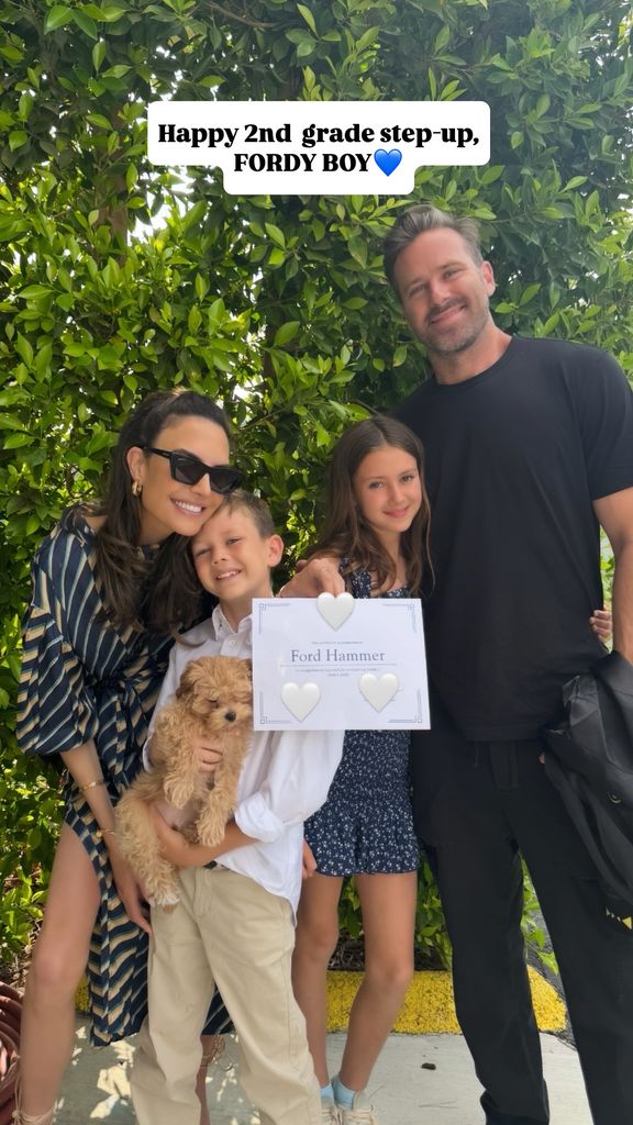 Armie Hammer, Elizabeth Chambers and their children Ford and Harper pose for a photo celebrating the former's move up to 2nd grade, shared on Instagram