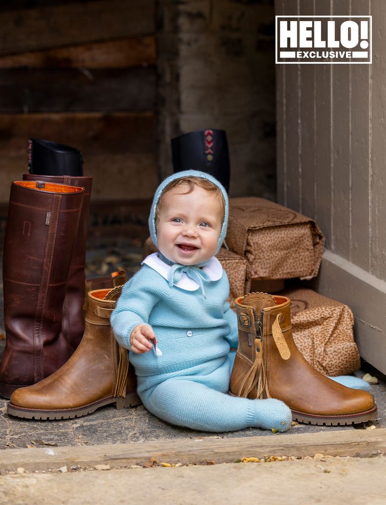 Penelope Chilvers' grandchild posing with boots at Cotswolds home