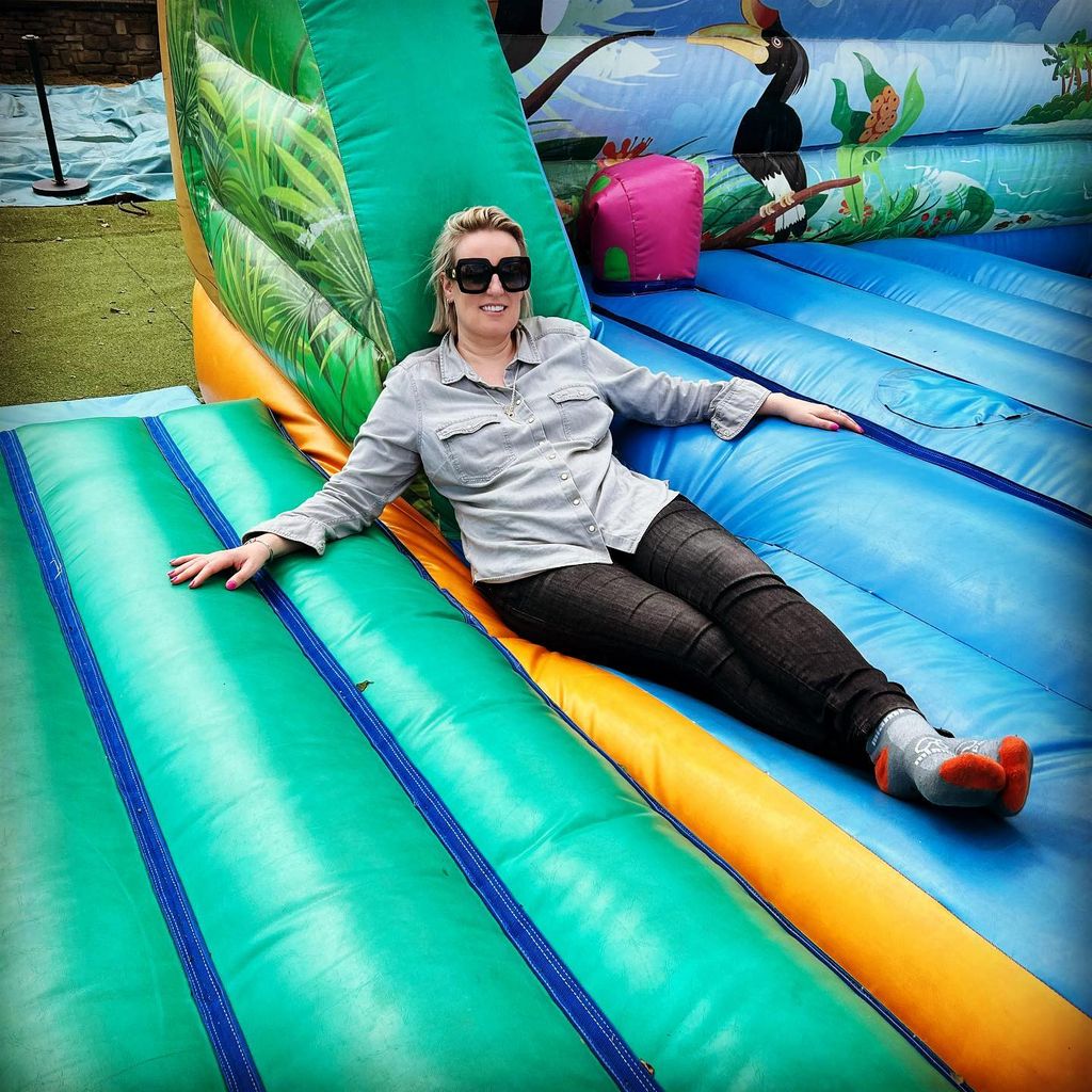 Steph McGovern sitting on a bouncy castle