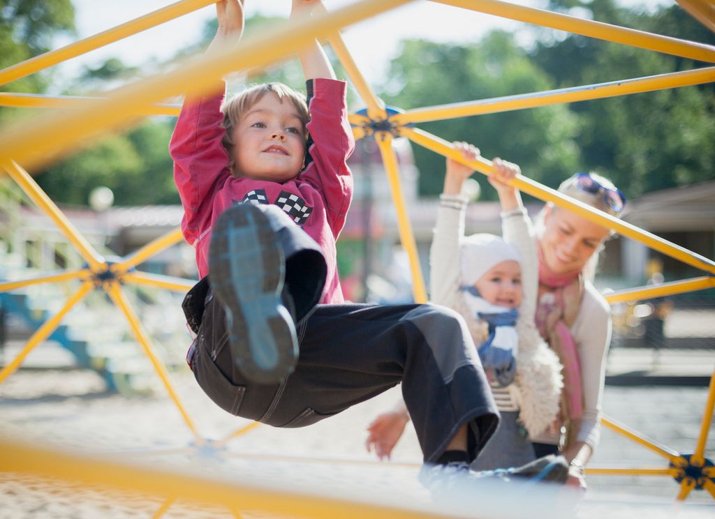 children climbing on a playground - Exciting activities to do with your kids over the summer holidays
