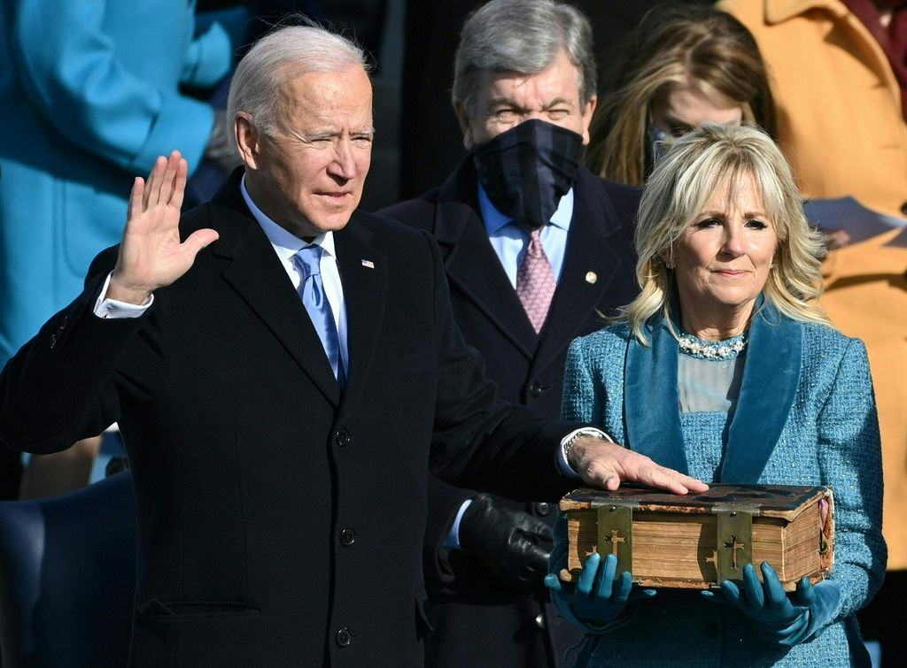 Joe Biden, flanked by incoming US First Lady Jill Biden takes the oath of office as the 46th US President