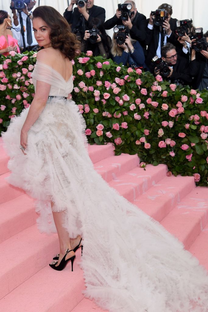 Ruth Wilson in a white dress on pink steps at the Met Gala