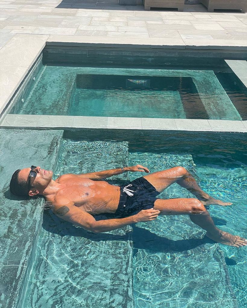 Mark Consuelos lounges in the pool in a photo shared by Kelly Ripa on Instagram