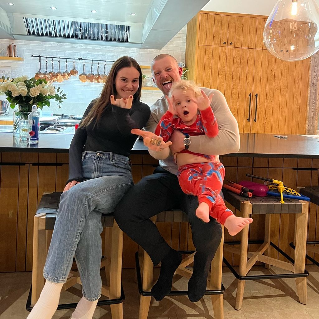 holly ramsay and adam peaty with his son in kitchen