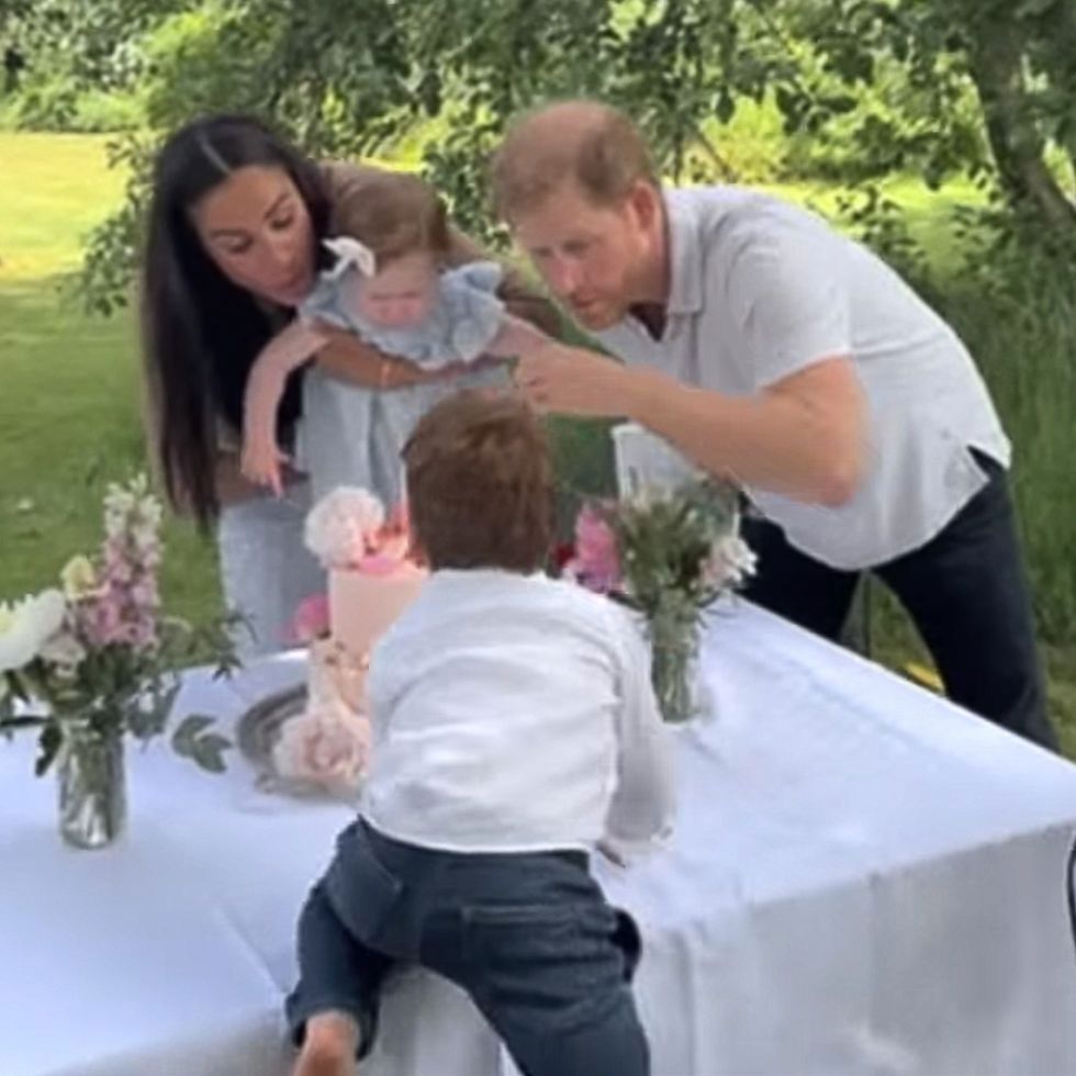 Meghan Markle, Prince Harry, Archie and Lilibet blowing a birthday candle