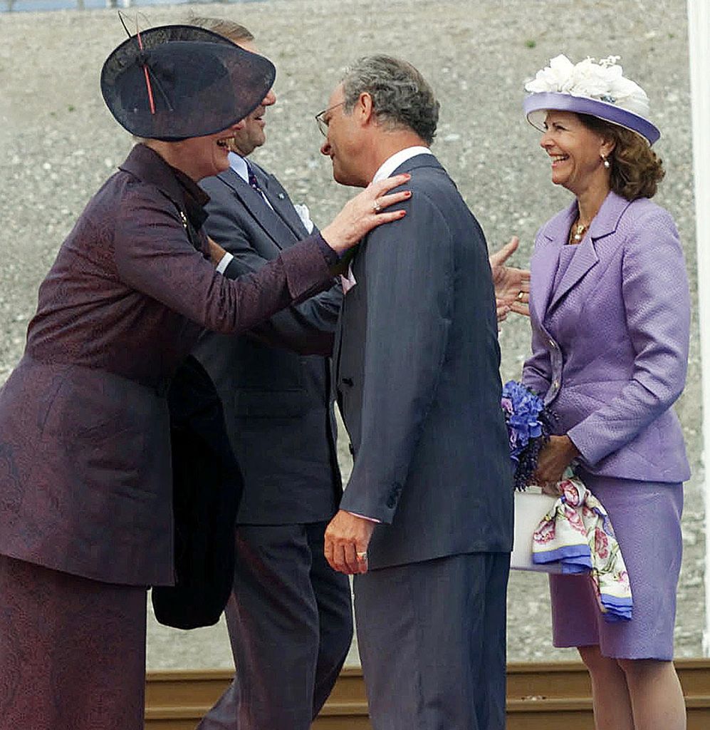 Queen Margrethe II and Prince Consort Henrik of Denmark, left, King Carl XVI Gustaf and Queen Silvia of Sweden embrace Saturday July 1, 2000