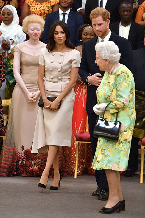 meghan smiles at the queen