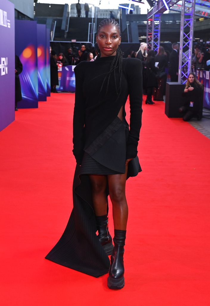 Michaela Coel in all black outfit and chunky boots