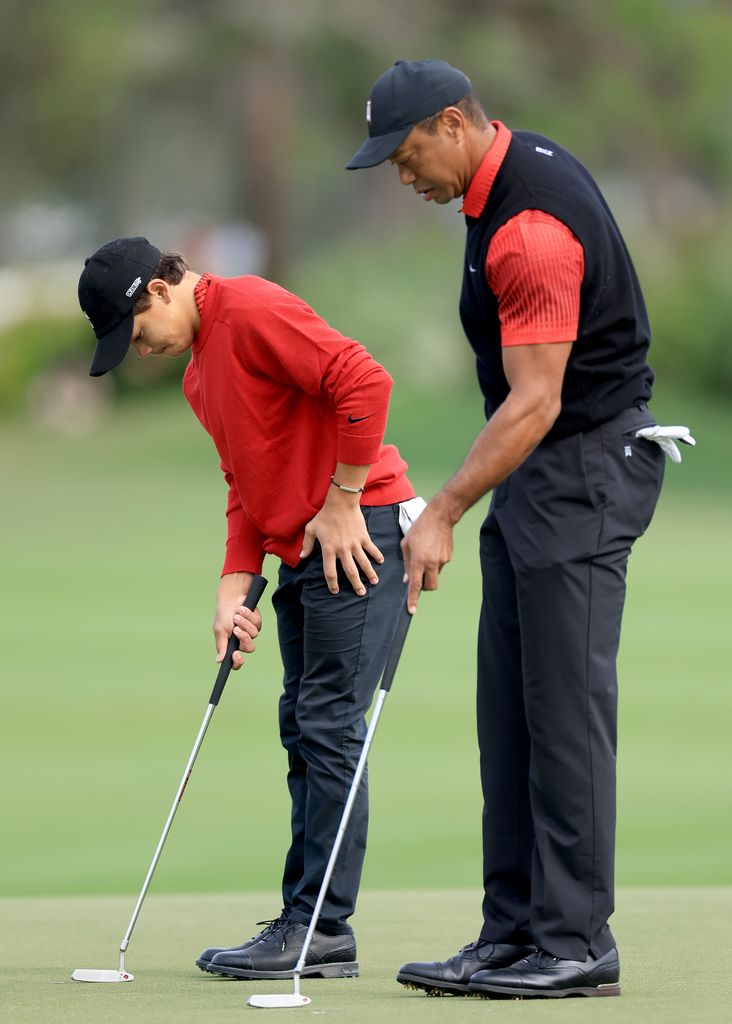 Tiger Woods of The United States lines up a putt with his son Charlie Woods on the second hole during the final round of the 2022 PNC Championship at The Ritz-Carlton Golf Club on December 18, 2022 in Orlando, Florida. (Photo by David Cannon/Getty Images)