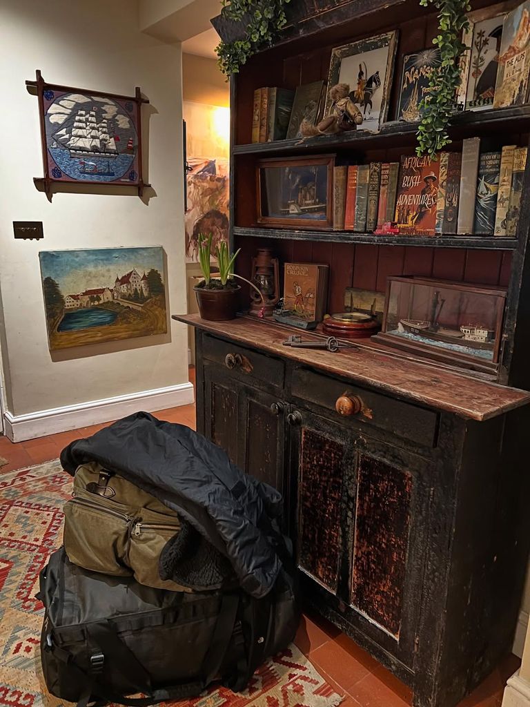 Ben Fogle's hallway with his packed bags in front of a wooden dresser