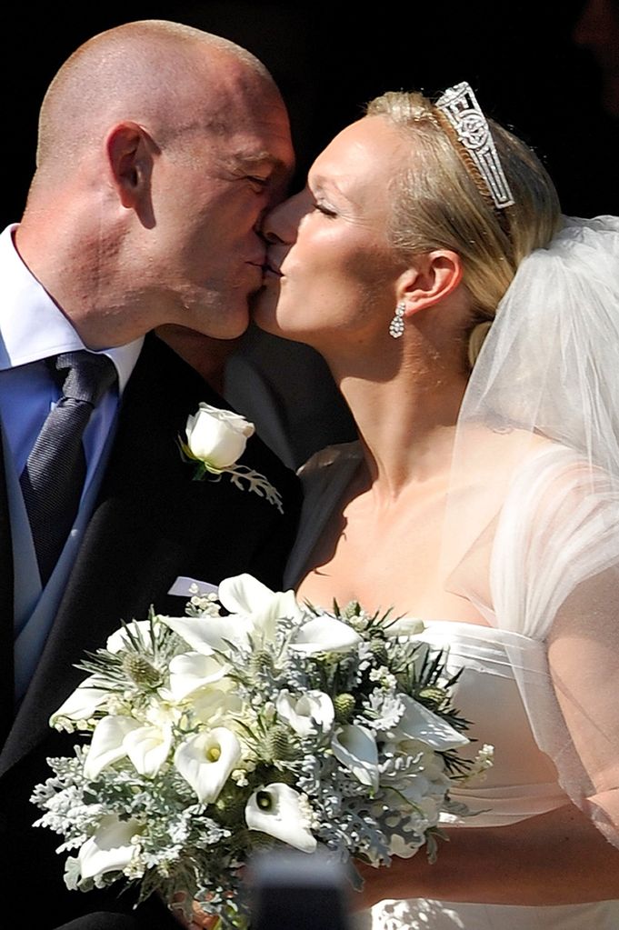 England rugby captain Mike Tindall and Zara Phillips kiss as they leave the church after their marriage at Canongate Kirk