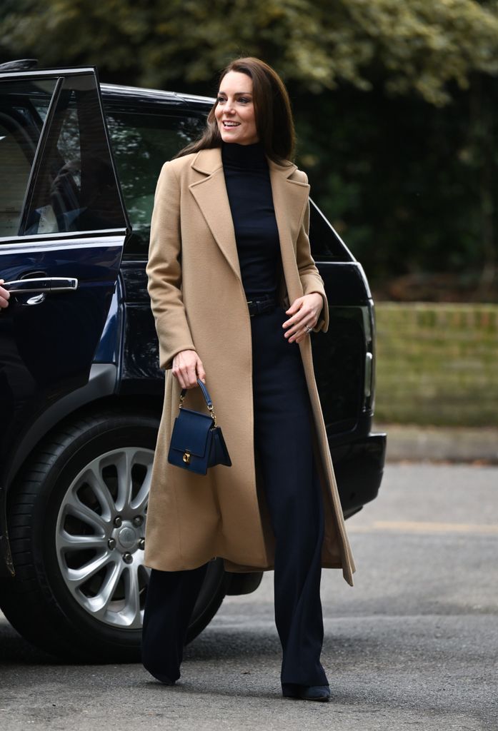 Kate also styled her camel coat with navy pieces