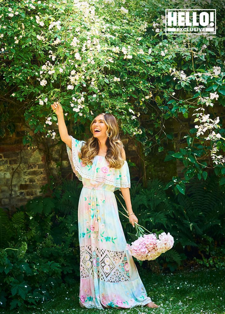 Ayda Field Williams reaches for the flowers in the garden