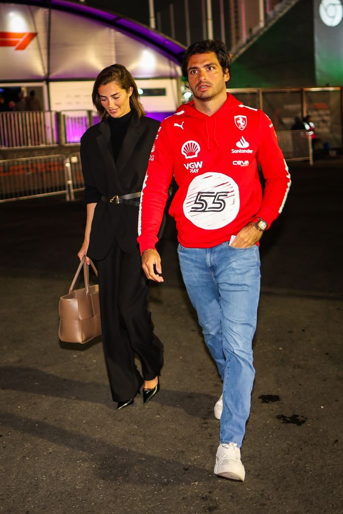 Carlos Sainz Jr walking with Rebecca Donaldson