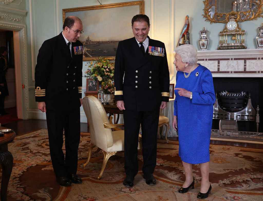 Queen Elizabeth II receives outgoing Commanding Officer, HMS Queen Elizabeth, Commodore Steven Moorhouse (C)  and incoming Commanding Officer, Captain Angus Essenhigh (L) during a private audience in the Queen's Private Audience Room