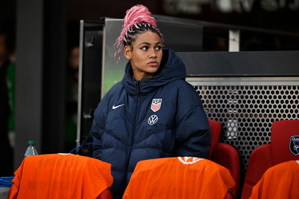 photo of trinity rodman sitting in stands at match